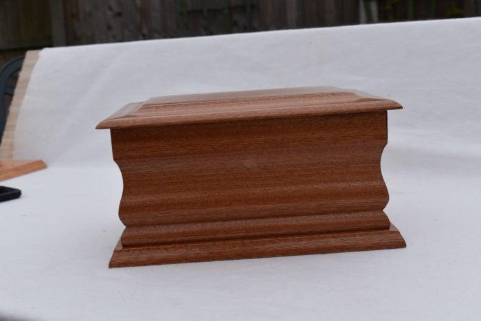 Mahogany casket with silver ring plaque side