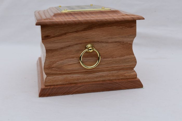 Oak casket with gold ring plaque end