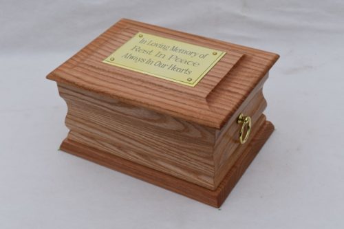 Oak casket with gold ring plaque top