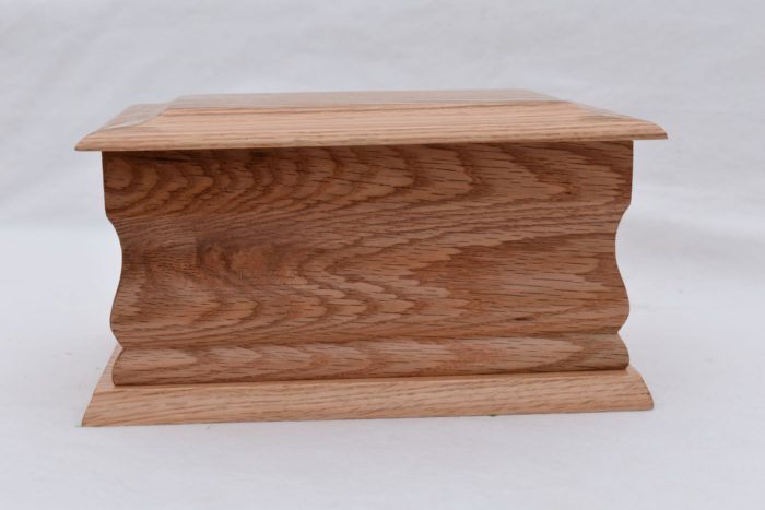 Oak casket with silver ring plaque side